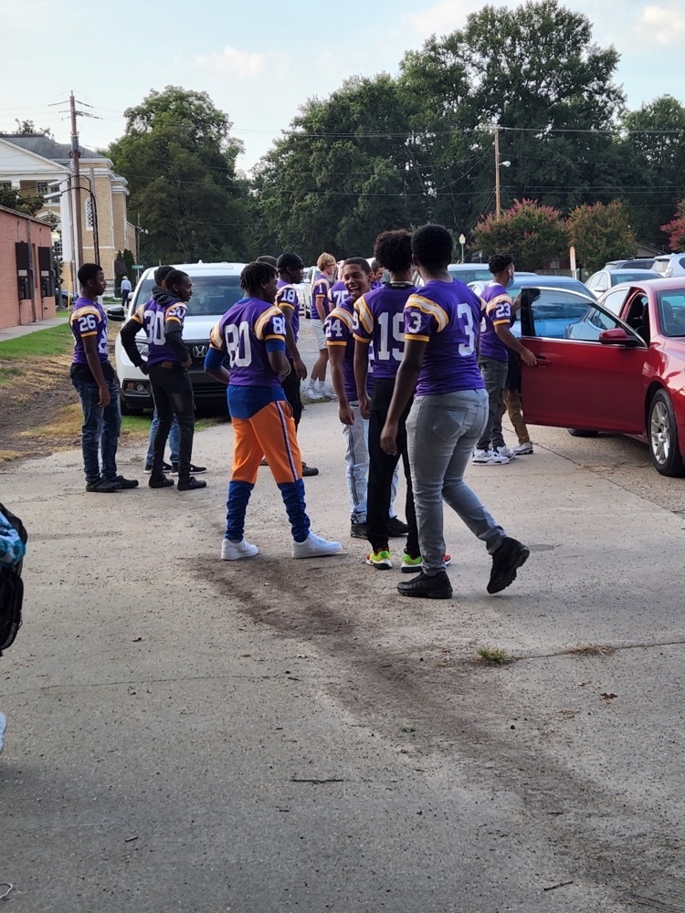 Football players helping with car drop off 