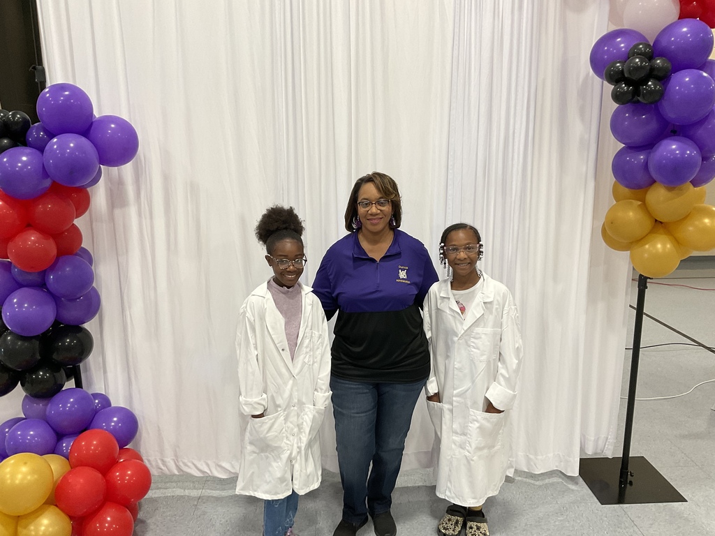 Superintendent Dr. Sterrett posing with two of the S.T.E.A.M students